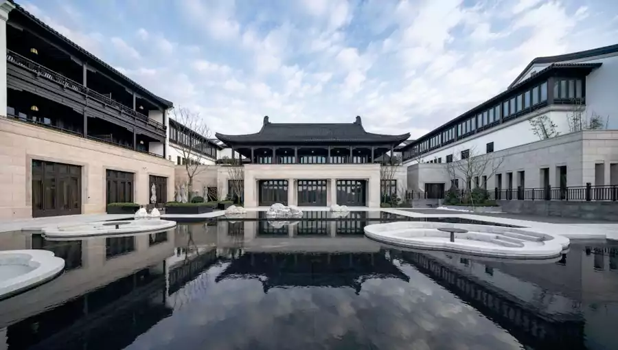 中式合院依山而建，青瓦灰牆與山間綠意渾然一體